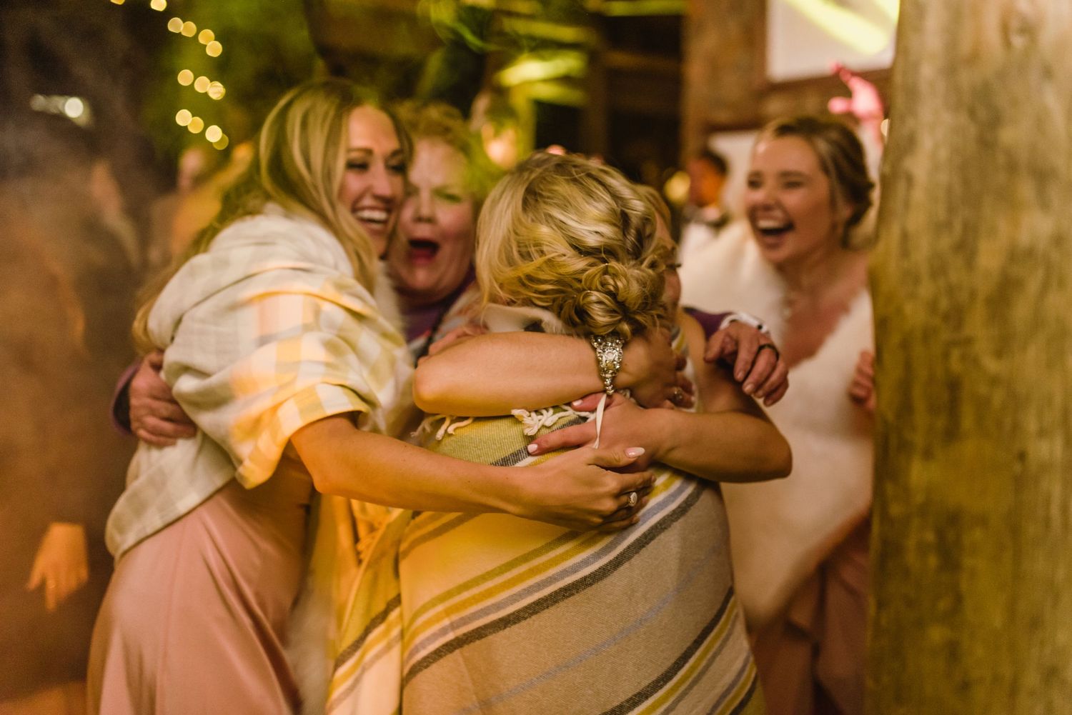 Celebratory dance moments captured during a rustic barn wedding reception.