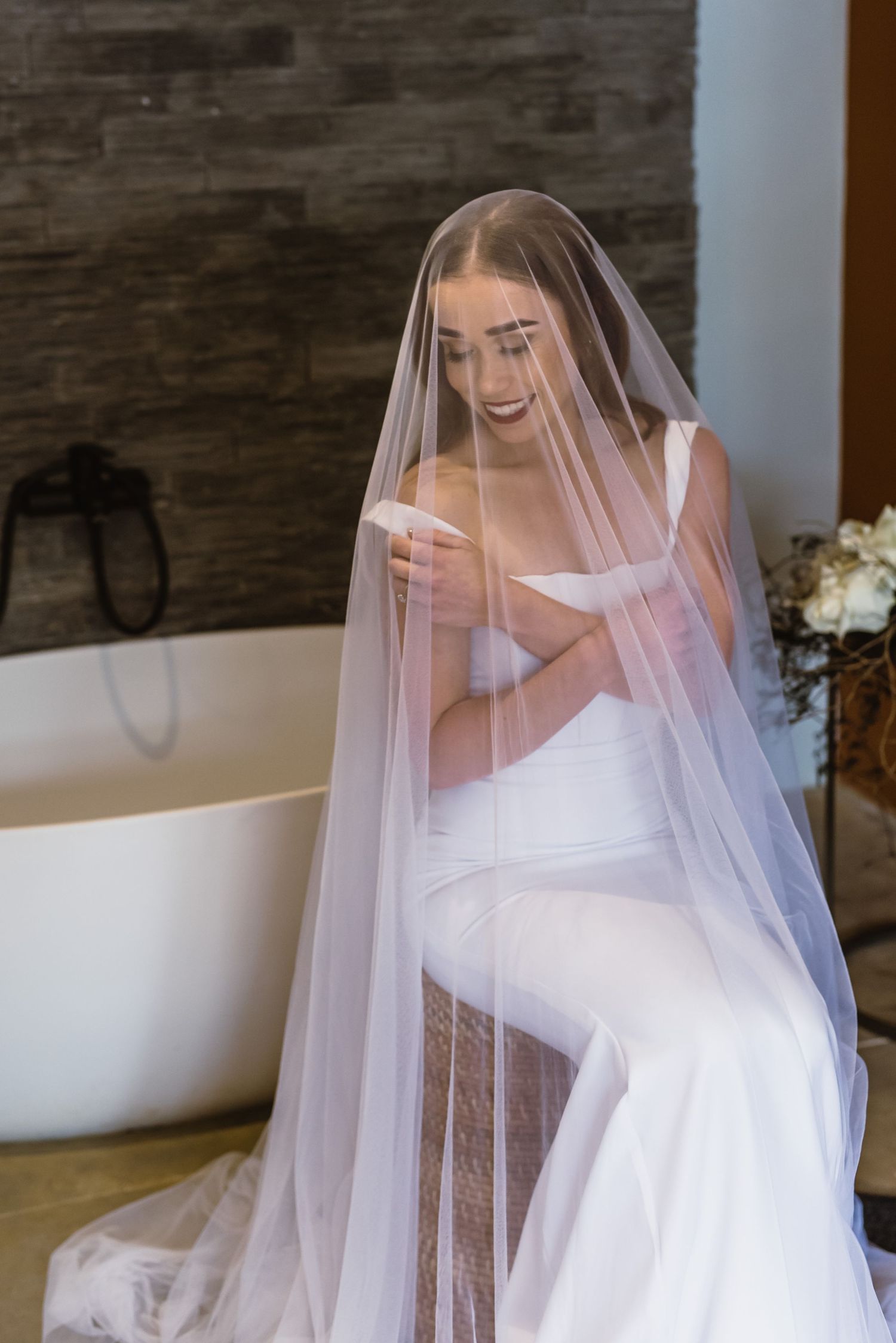 Ethereal bridal portrait with flowing veil creating romantic movement and drama.