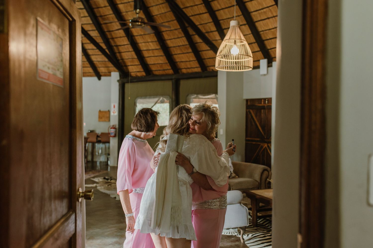 Interior of rustic venue with thatched roof and wooden beams.