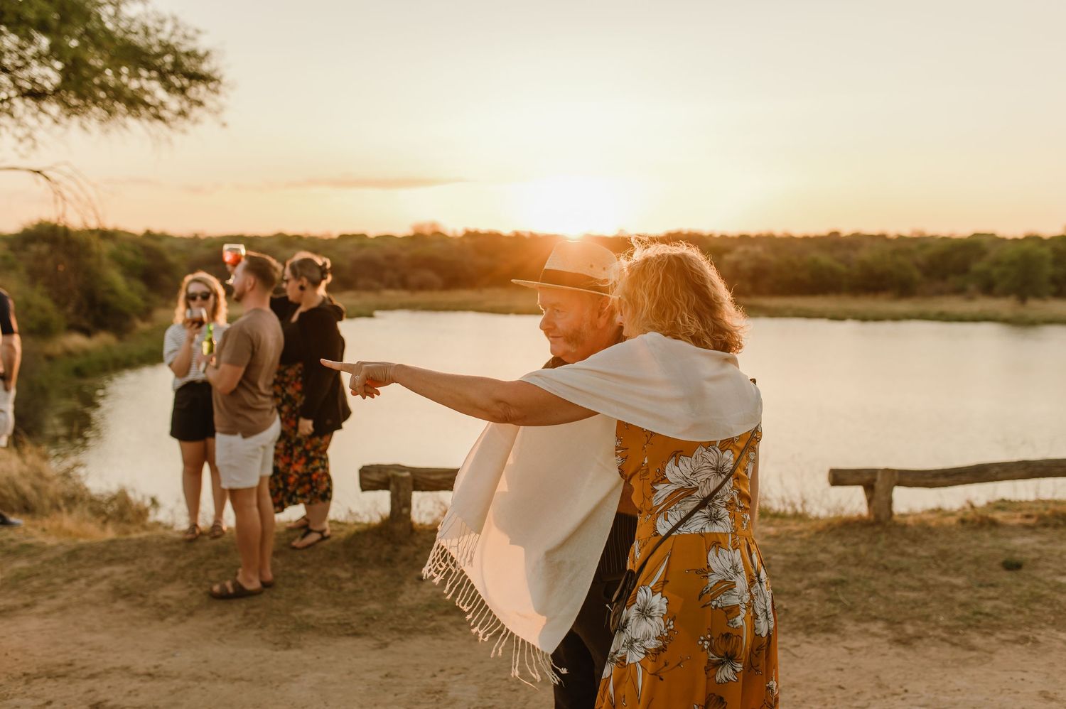Group enjoying sunset views during outdoor safari sundowner experience.