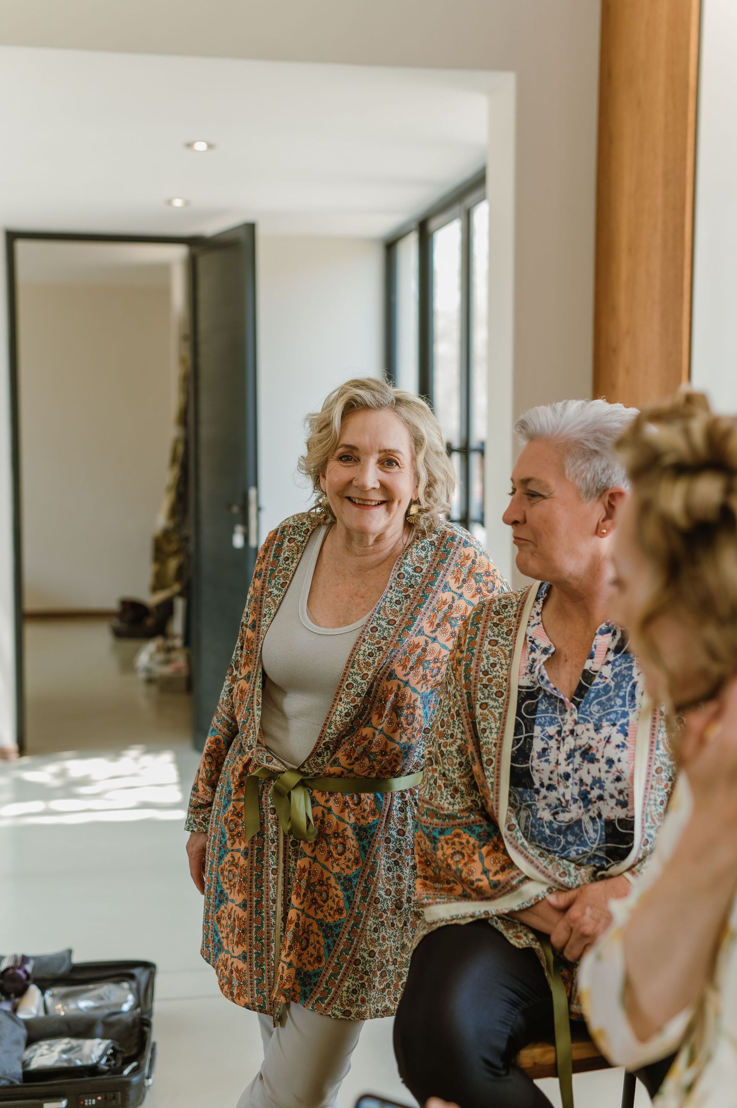 Candid moment of guests sharing laughter in a bright modern interior space.
