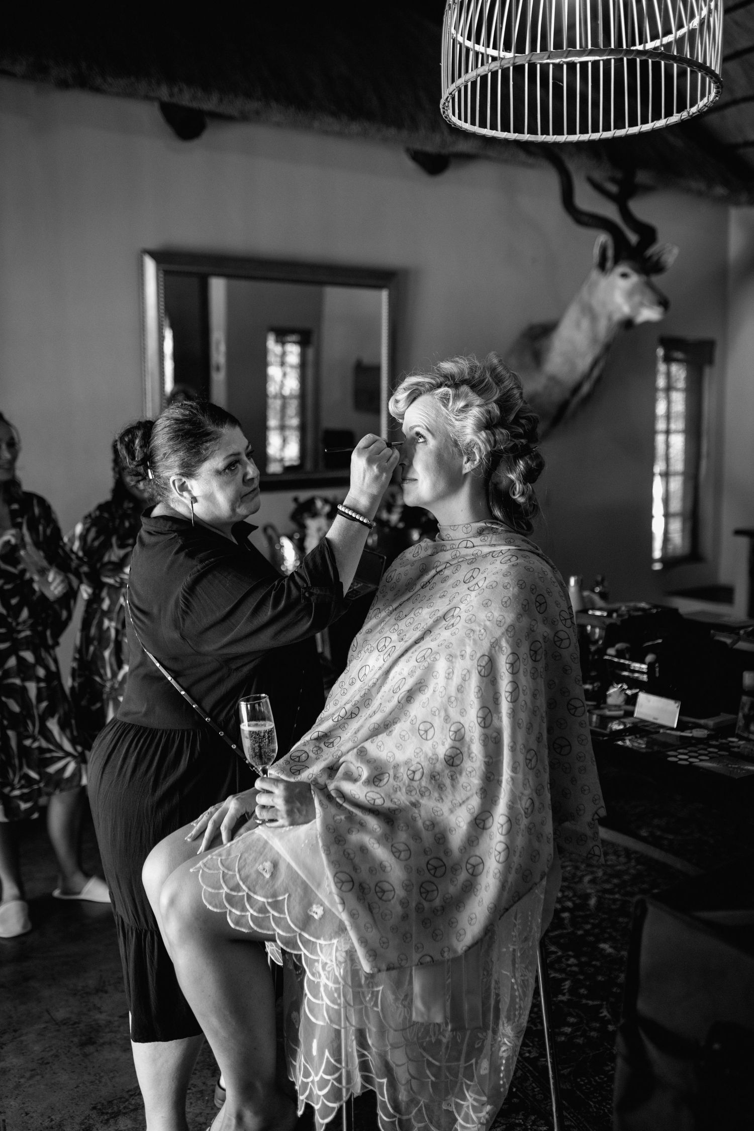 Black and white wedding photography sequence showing preparations with a bride in lace dress.