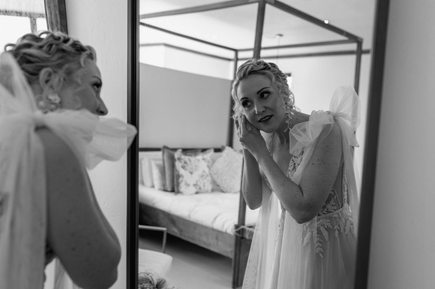 Black and white series of a bride getting ready in a dressing room with mirrors.