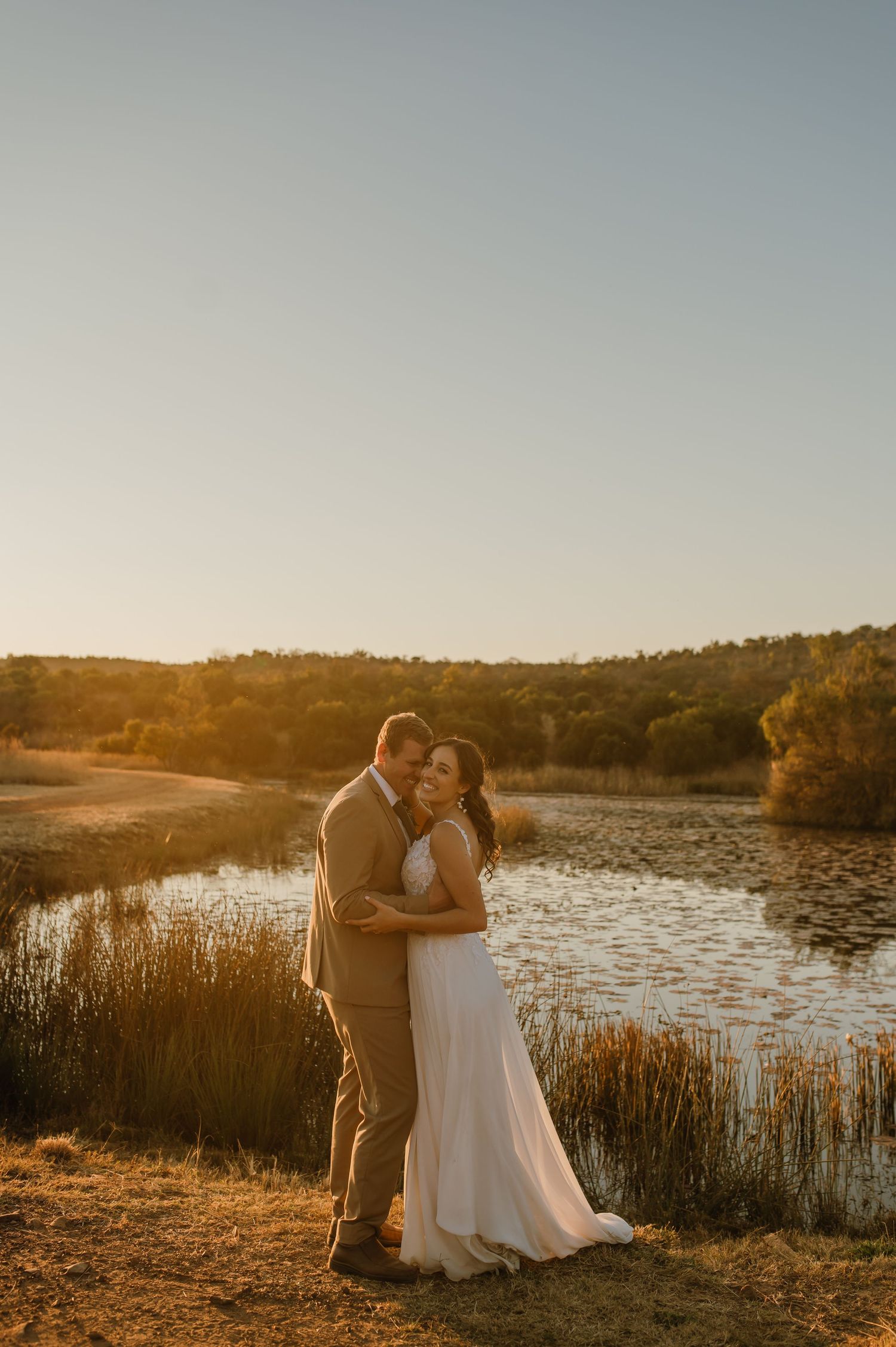 Intimate wedding moments photographed against lakeside setting at golden hour.