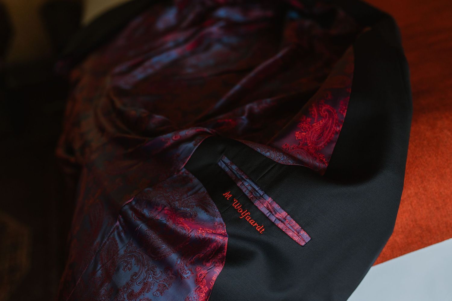 Detail shots of dark formal clothing with purple silk lining.