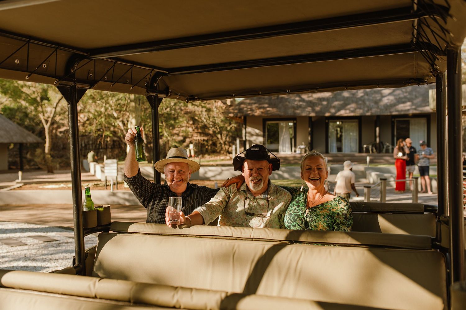 Safari-style covered vehicles parked in sequence under shaded outdoor area.