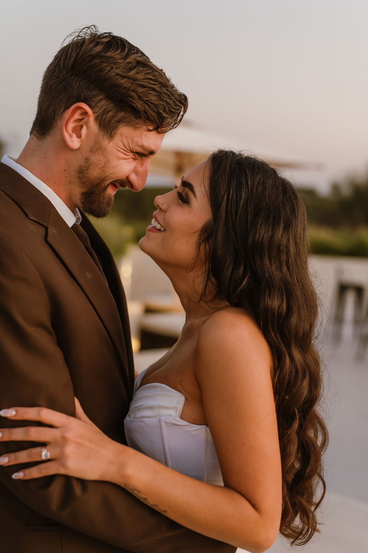 Close-up of romantic couple sharing intimate moment during sunset photoshoot.