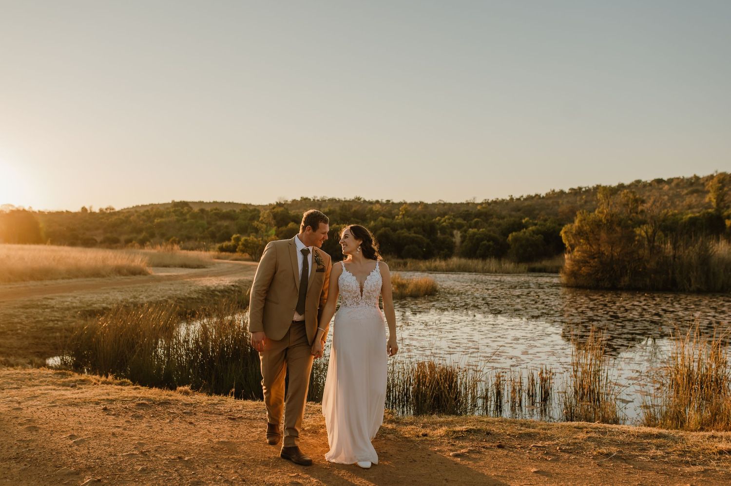 Romantic sunset wedding photography with lake and mountains in background.