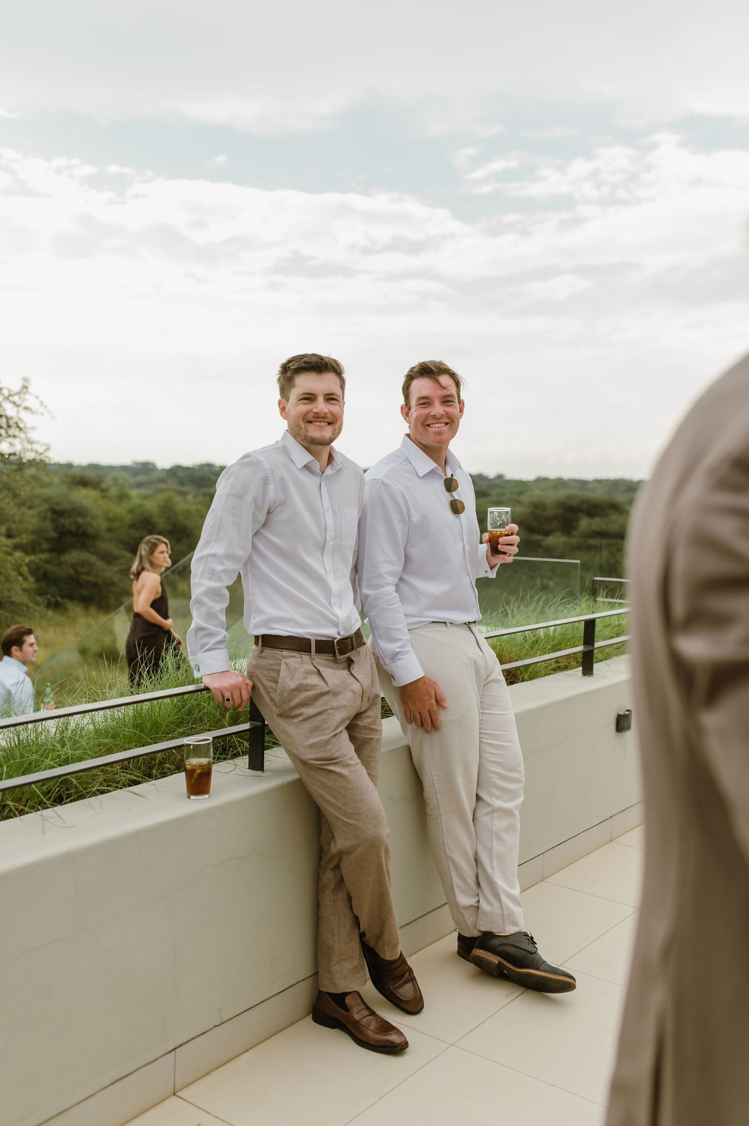 Guests enjoying drinks and conversation at an outdoor celebration.