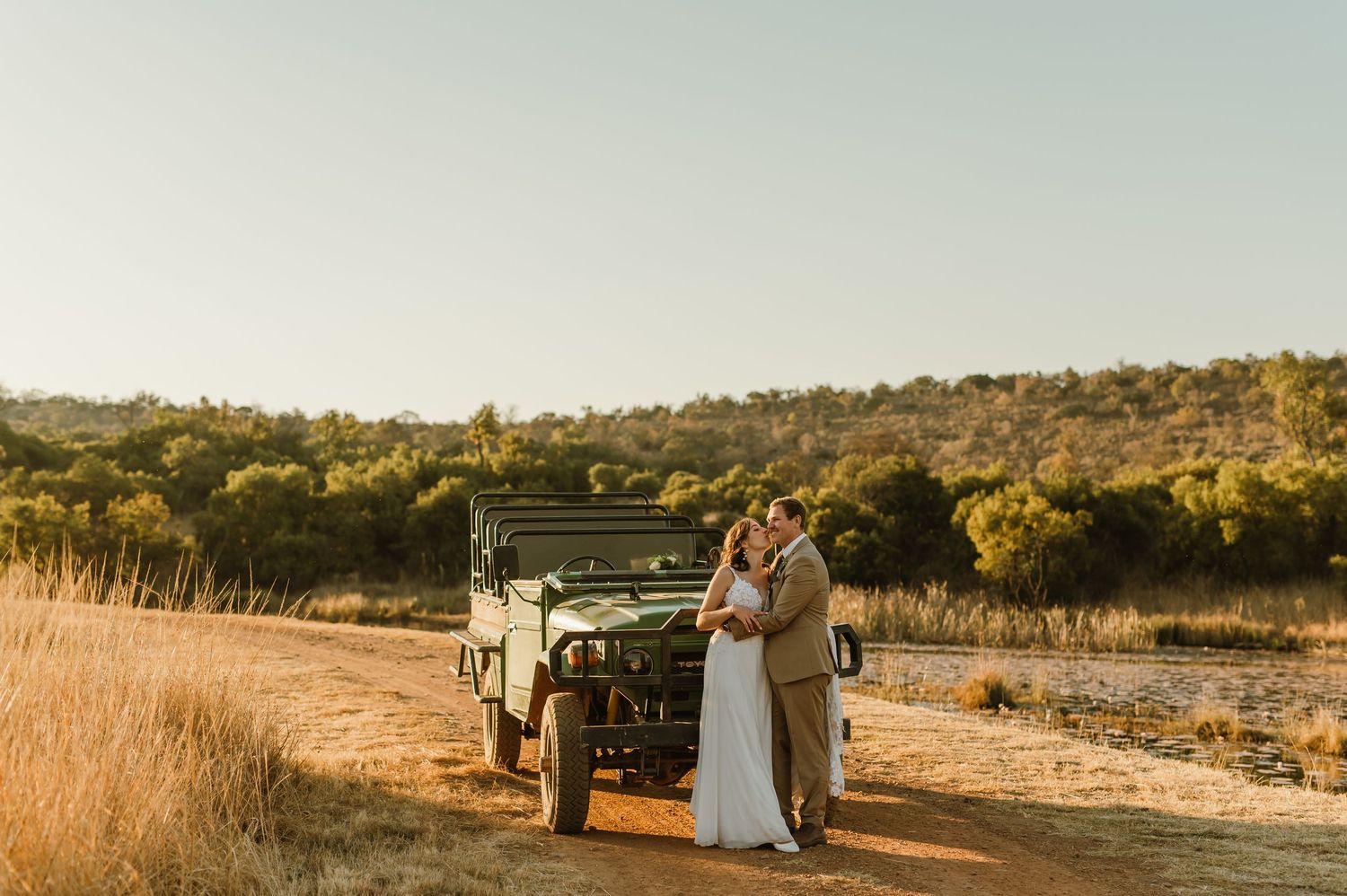 A scenic sunset wedding photoshoot with an off-road vehicle in a rural setting.