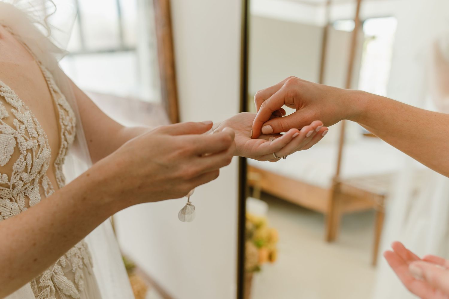 Close-up of hands exchanging wedding rings during a ceremony.