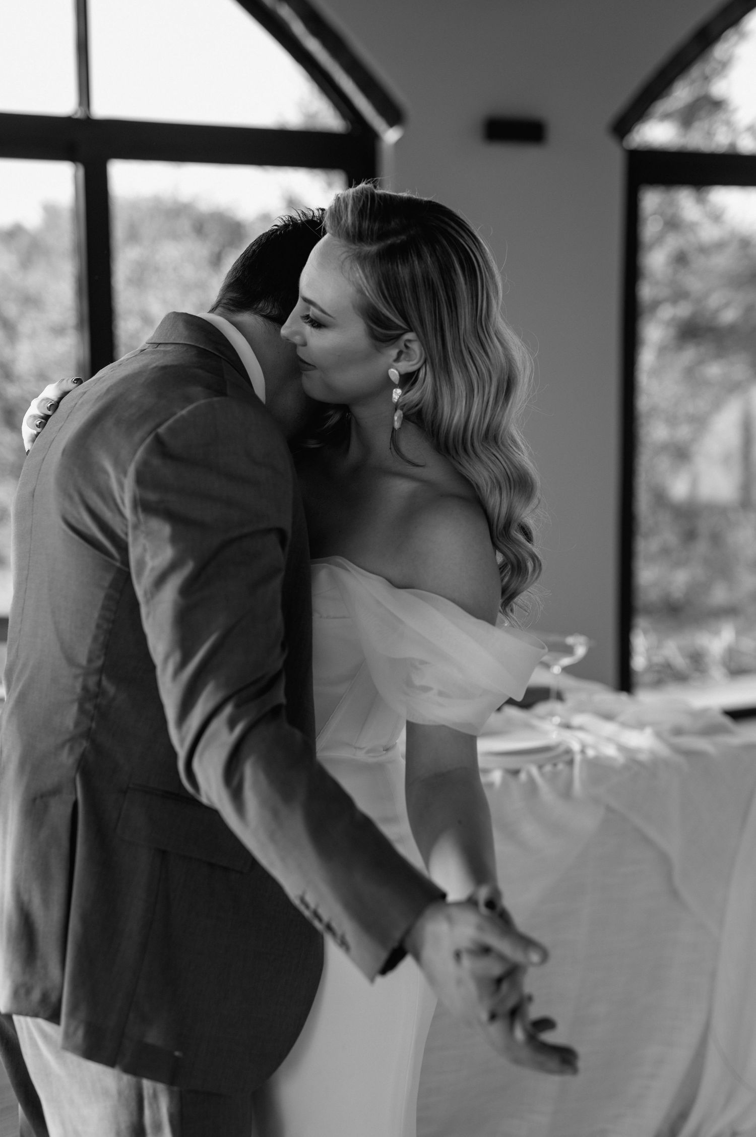 Intimate black and white moment captured during a wedding dance.