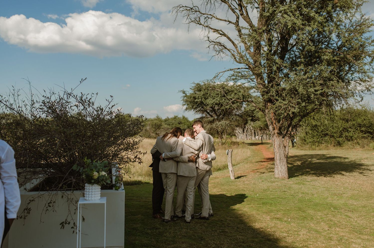 Scenic outdoor wedding venue setup with natural landscape and gathering guests.