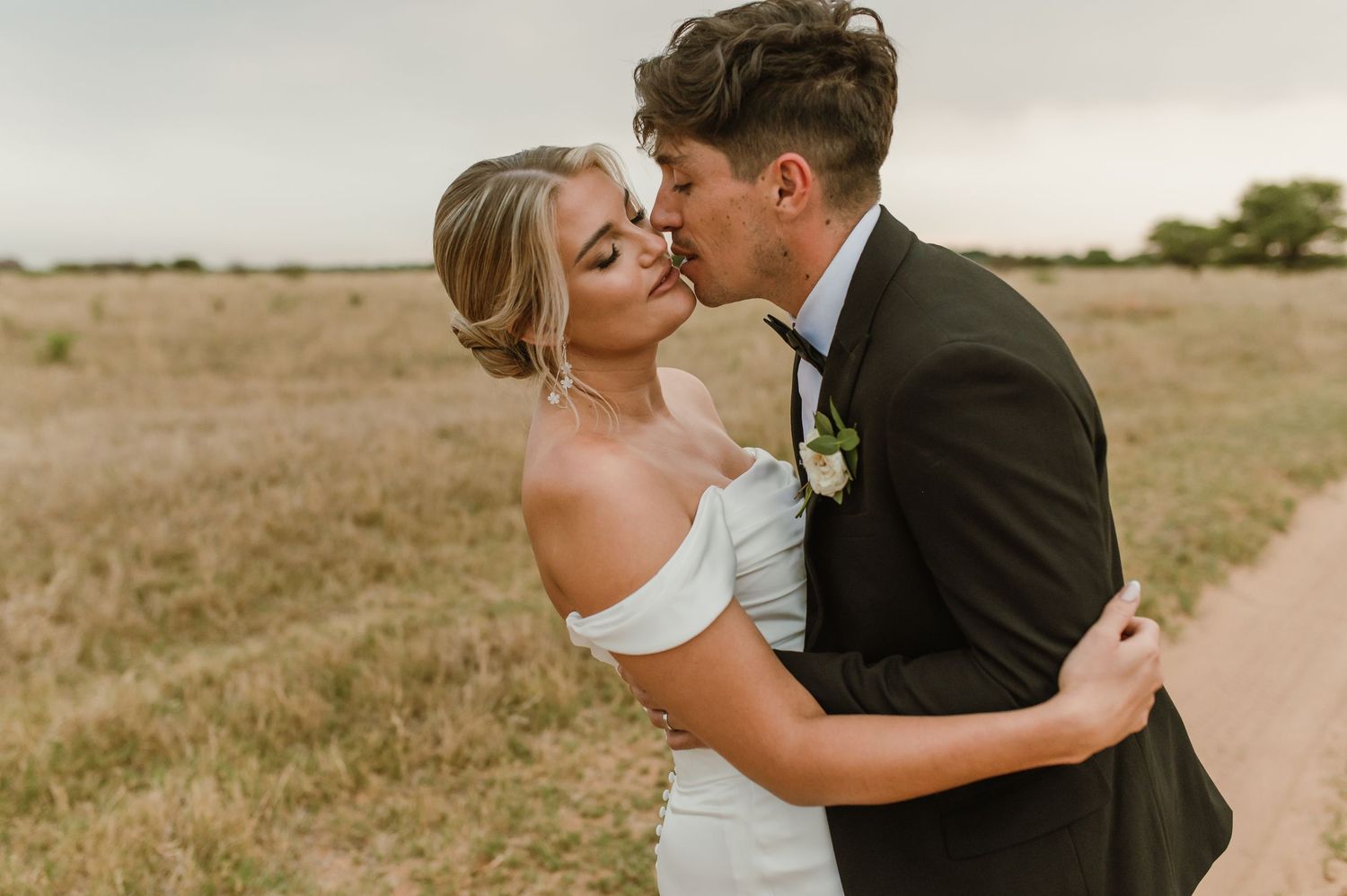 Romantic wedding photo sequence of couple embracing on rural path.