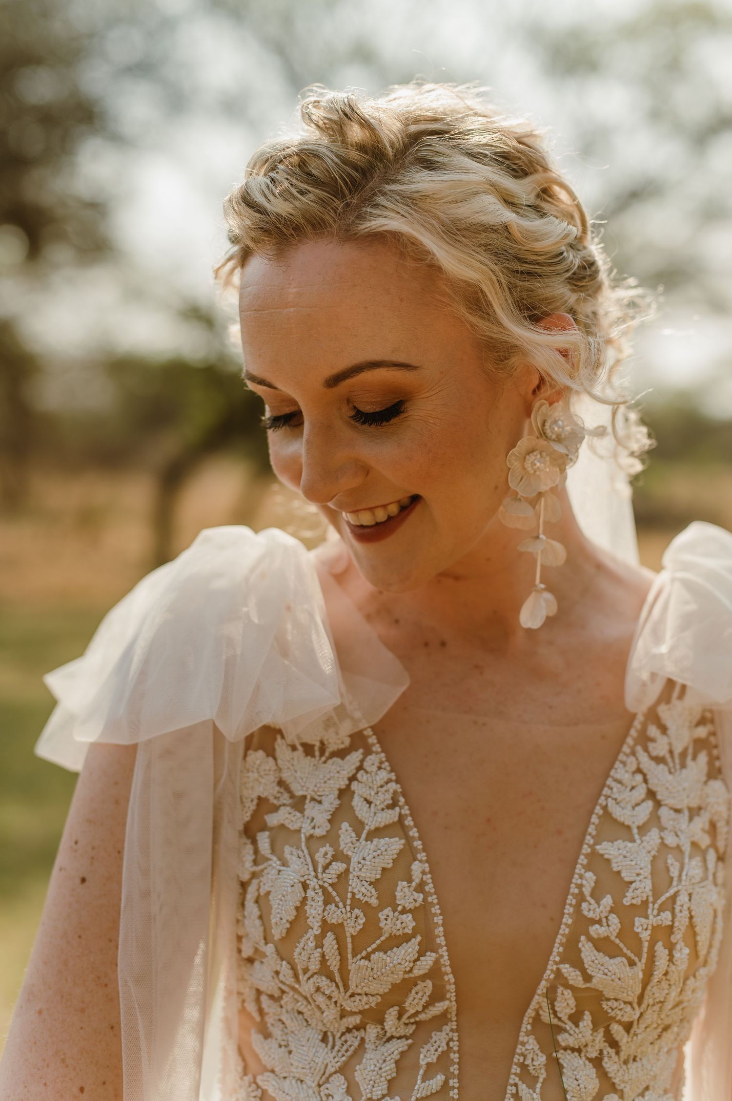 Close-up details of lace wedding dress with delicate embroidery patterns.