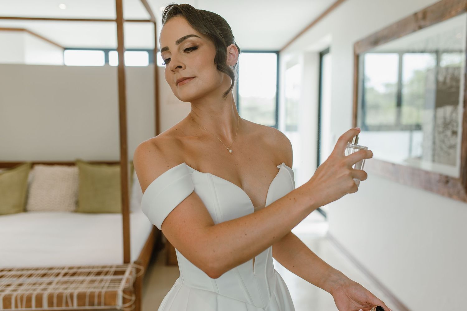 Close-up details of a structured white wedding dress with modern architectural elements.