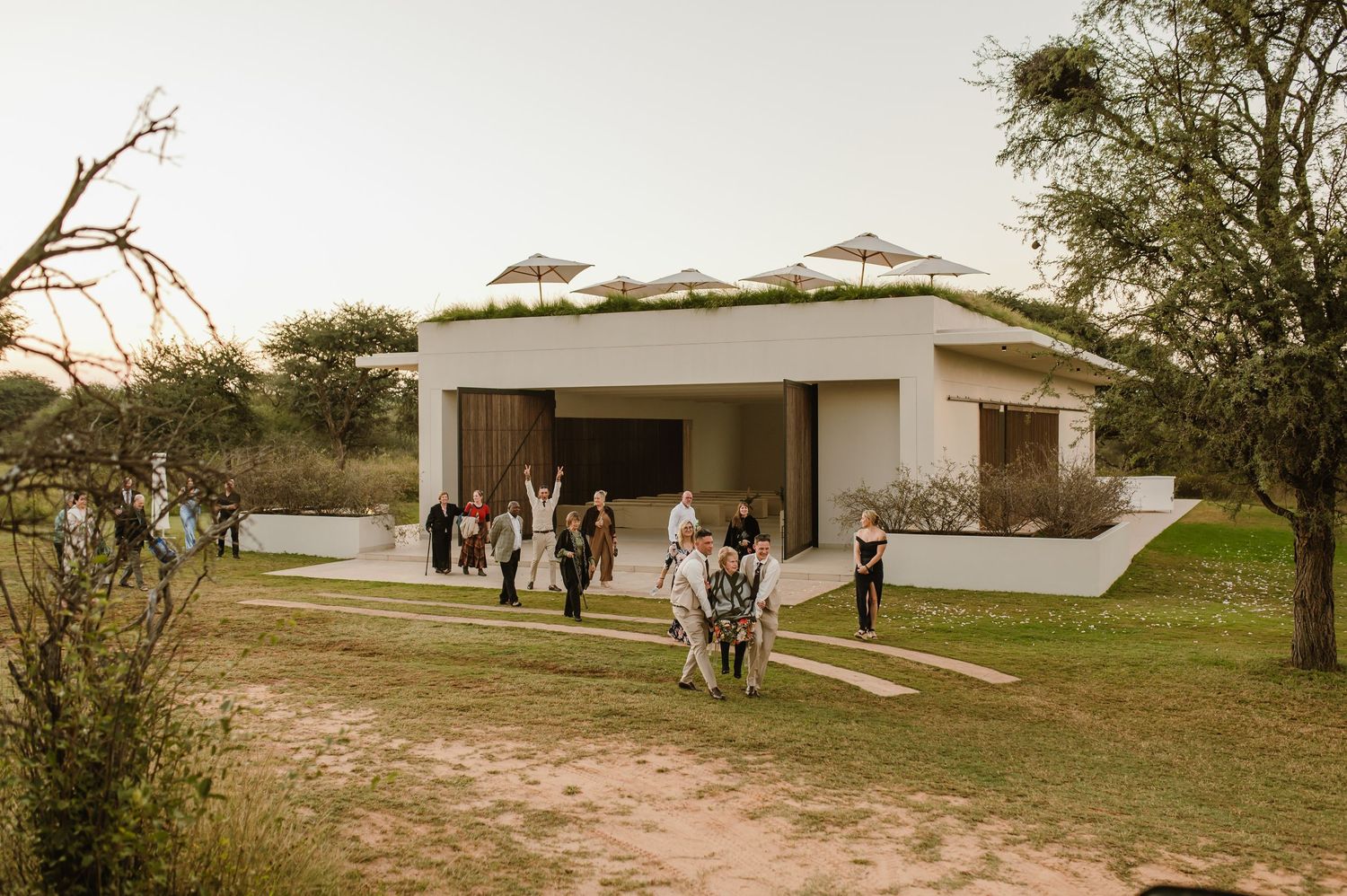 A modern white building with geometric architecture in an African landscape.