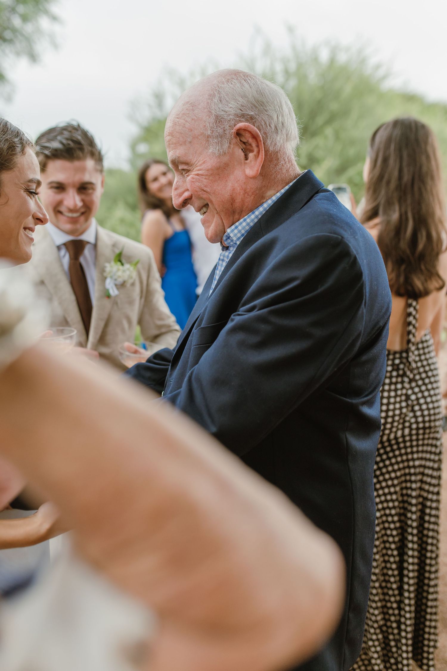 Candid moments captured during an outdoor wedding celebration.