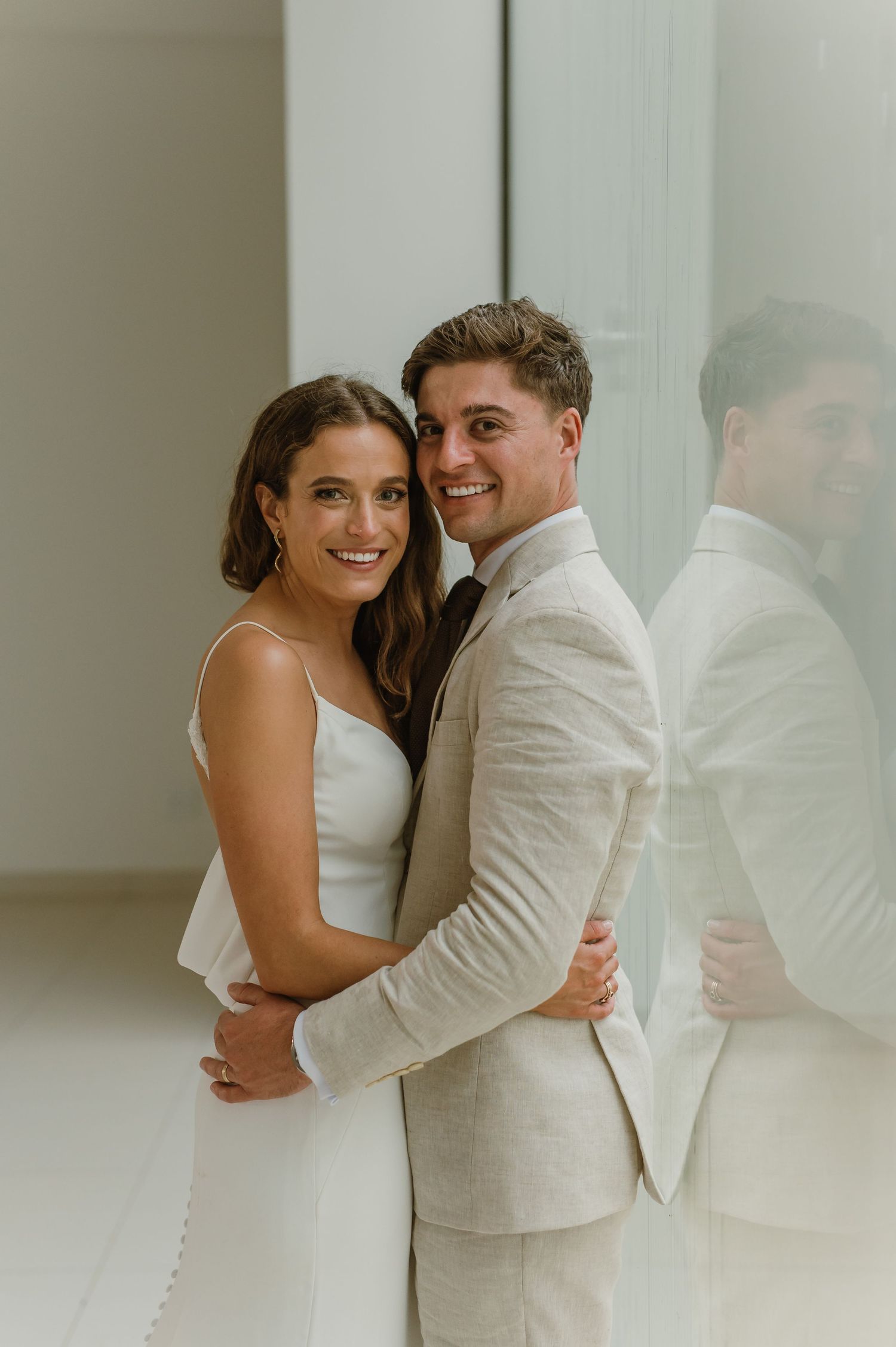 Happy couple sharing joyful moments in a bright, modern indoor space.