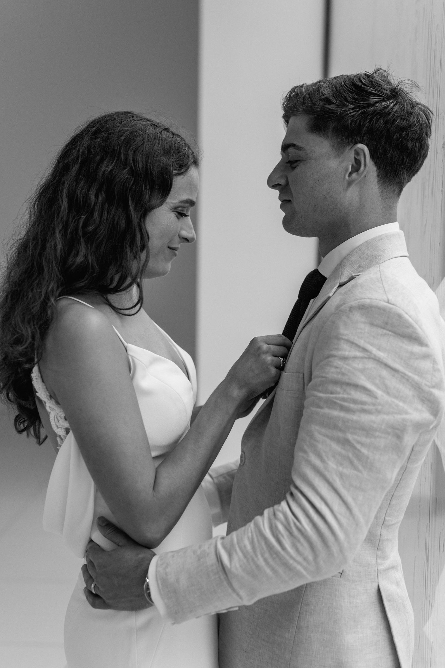 A romantic black and white photo sequence showing an intimate couple's embrace against a wall.