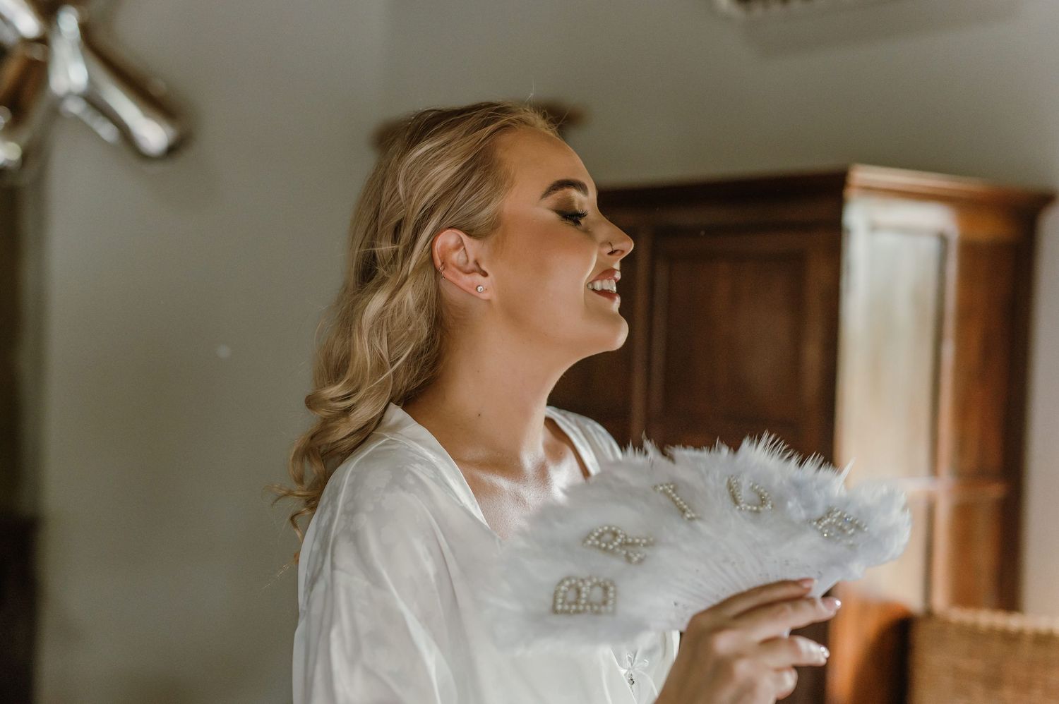 Bride preparation sequence showing makeup application in natural light.