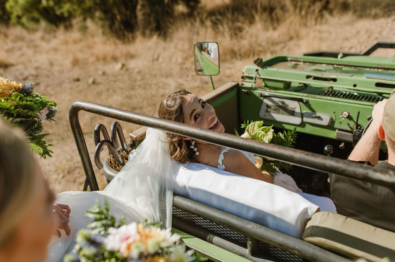 Adventure vehicle decorated with floral arrangements parked in a desert setting.