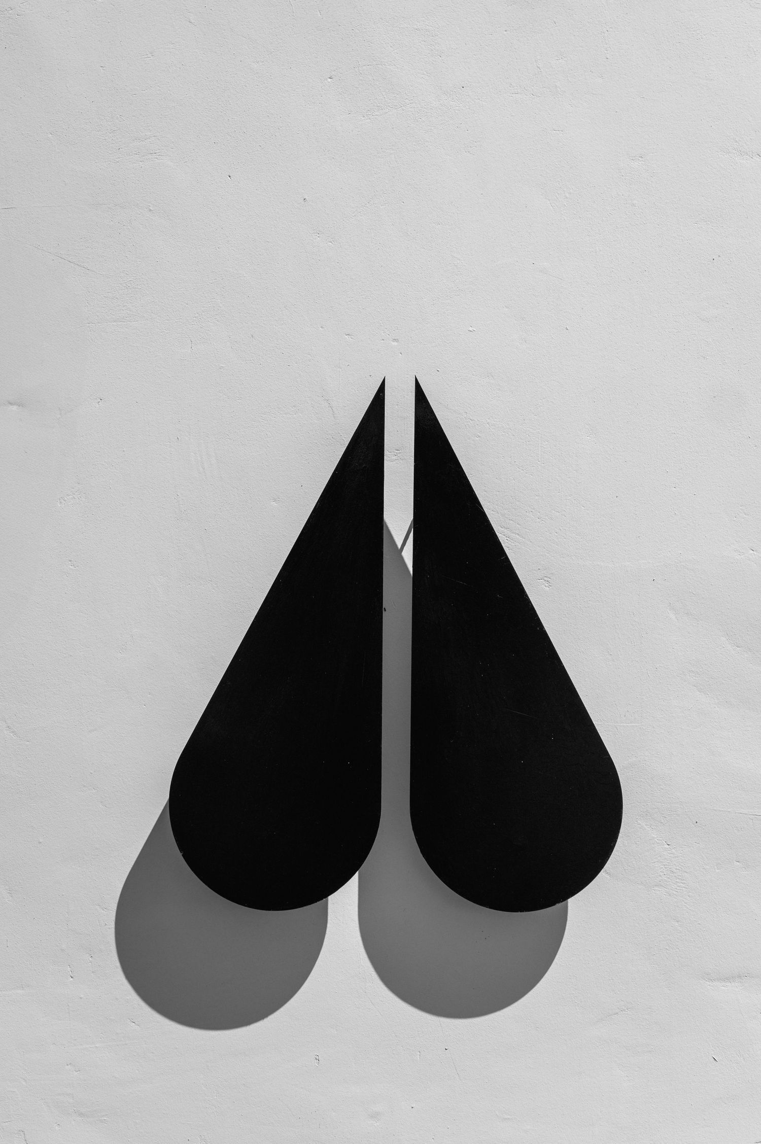 Minimalist black teardrop logo design on white background showing progressive size variations.