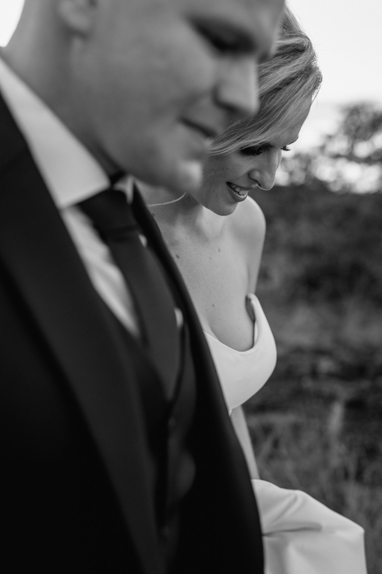 Black and white close-up portrait of a couple sharing an intimate moment.