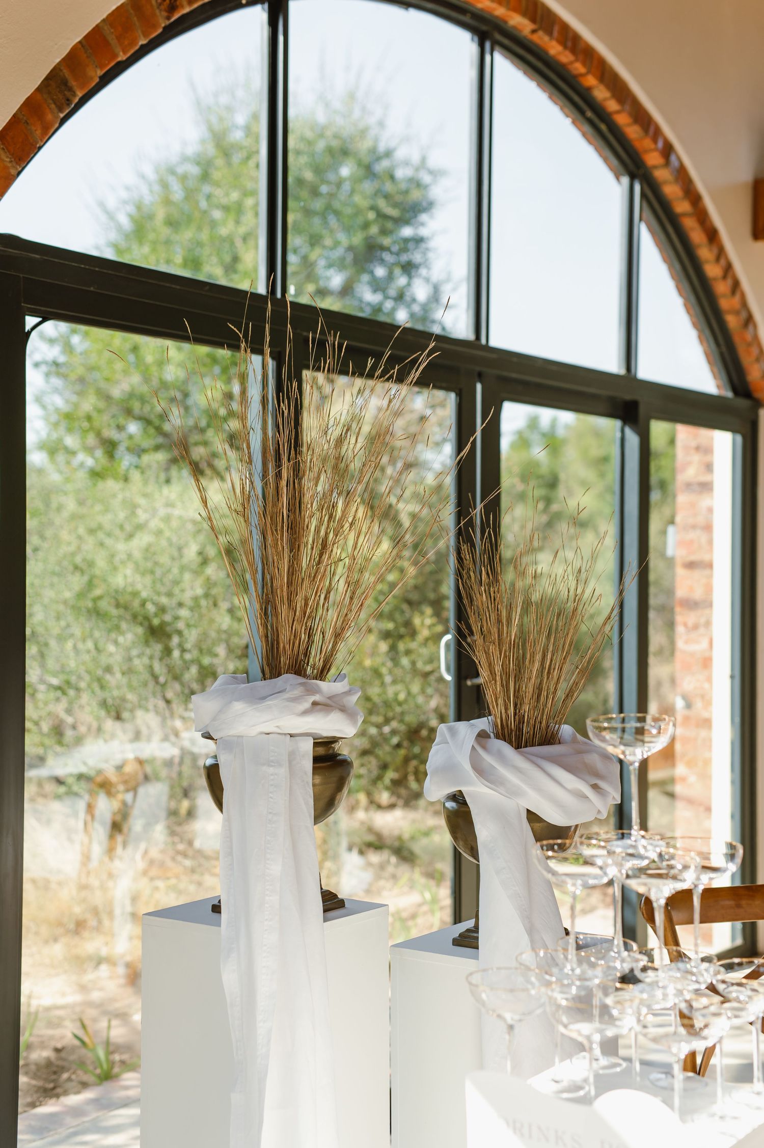 Wedding reception venue with arched windows and elegant table settings.