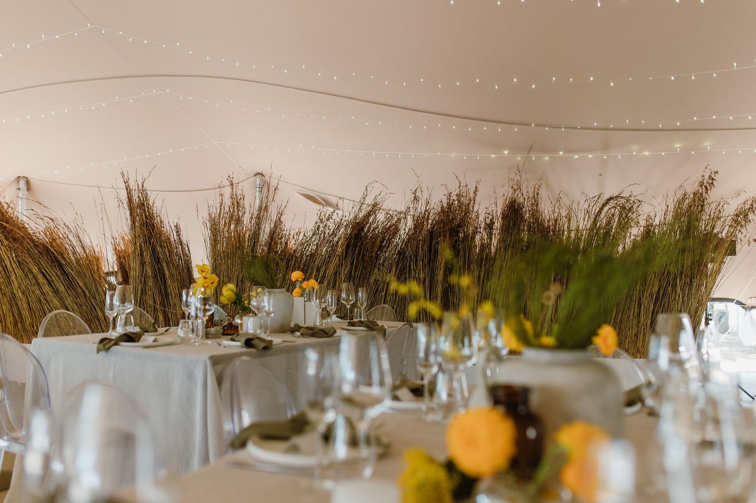 Elegant table setting with rustic decor and dried floral arrangements at a modern event venue.