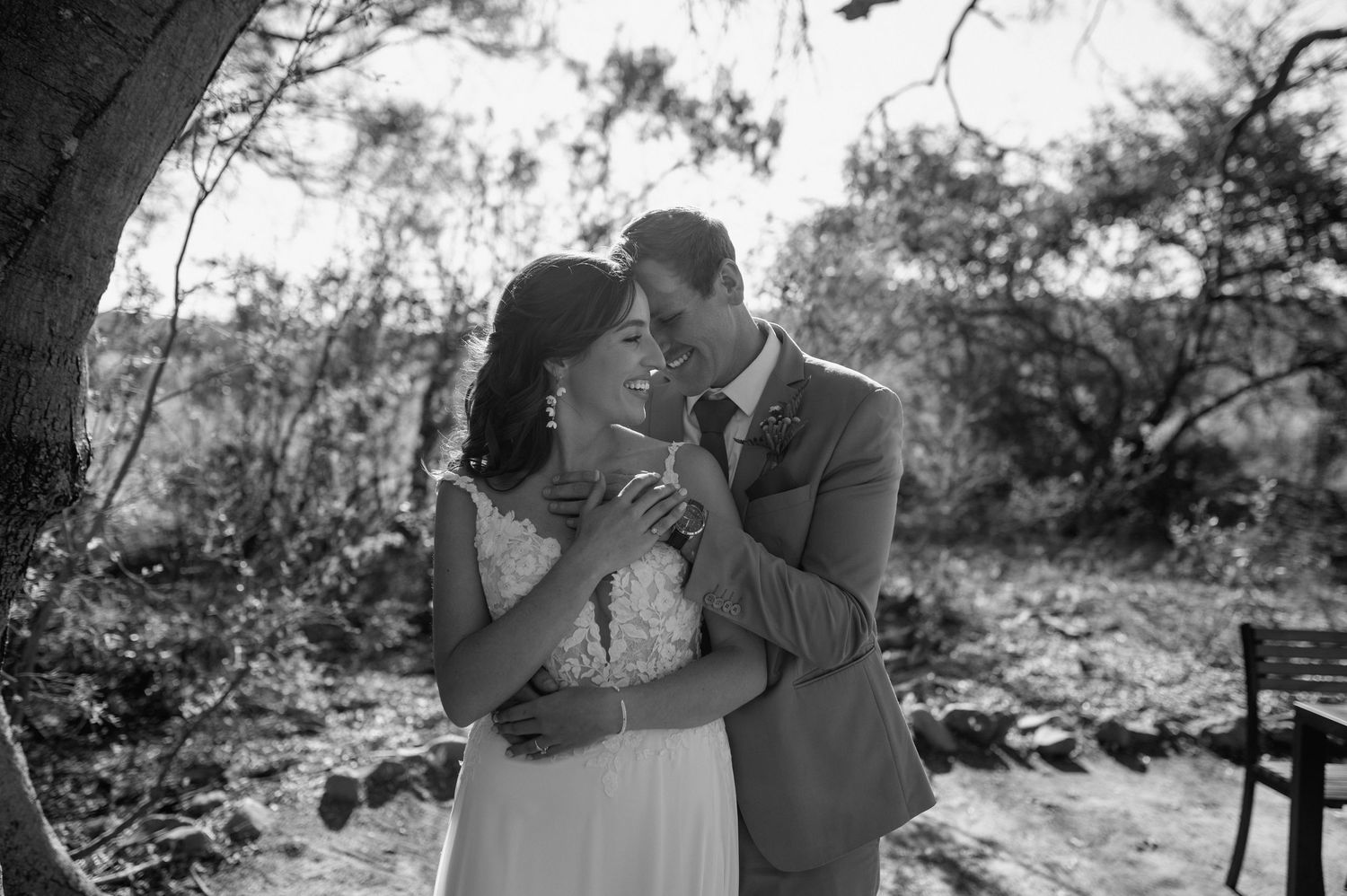 Series of romantic black and white wedding photos taken in a natural setting.