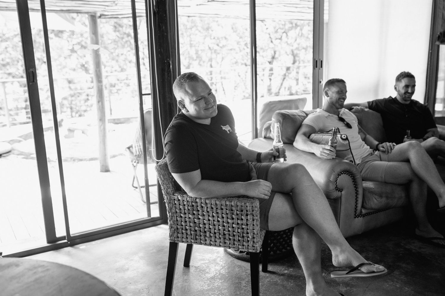 Interior view of a rustic lounge area with people relaxing on comfortable seating.