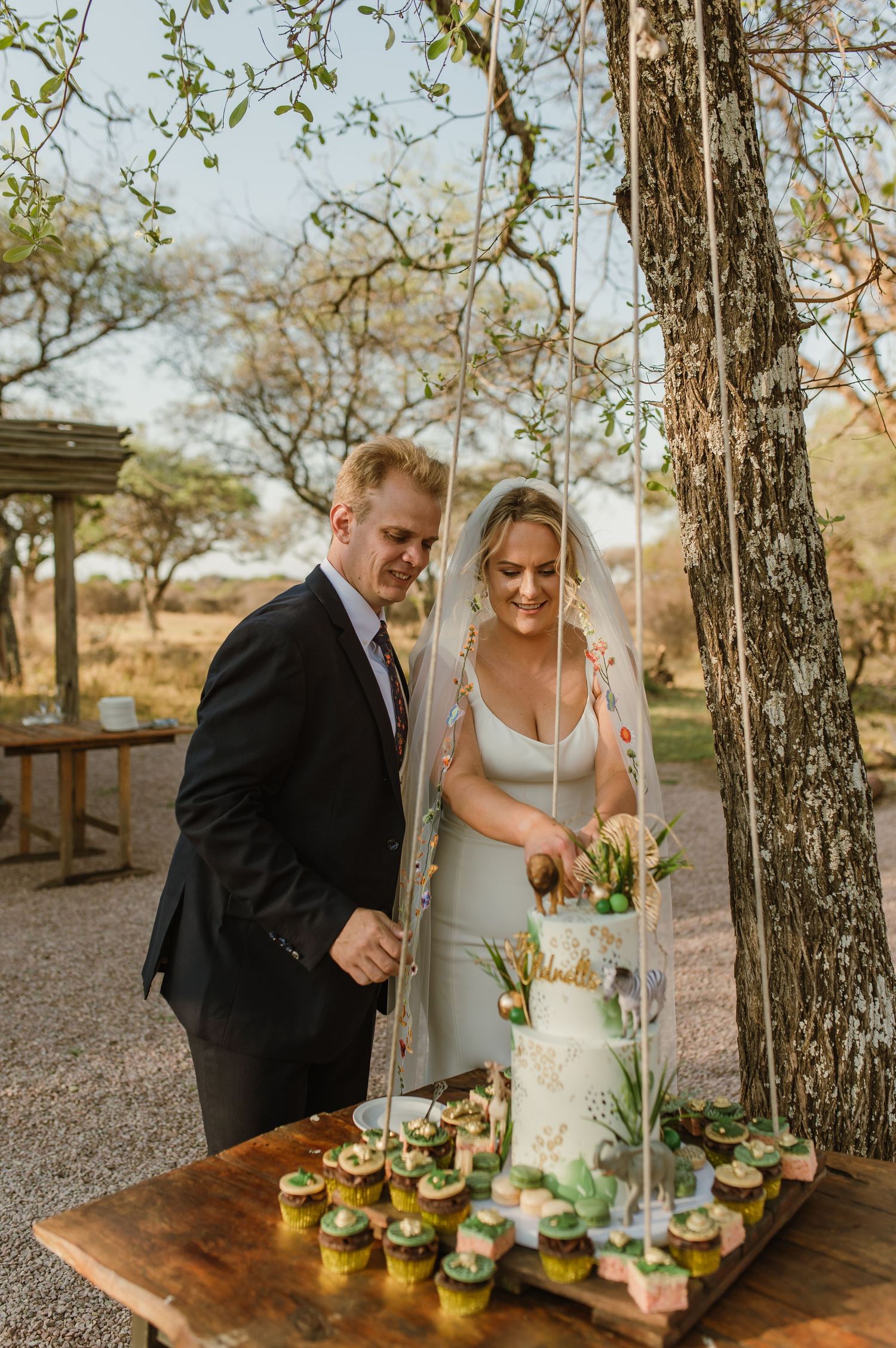 A couple enjoying appetizers at a rustic wooden table outdoors.