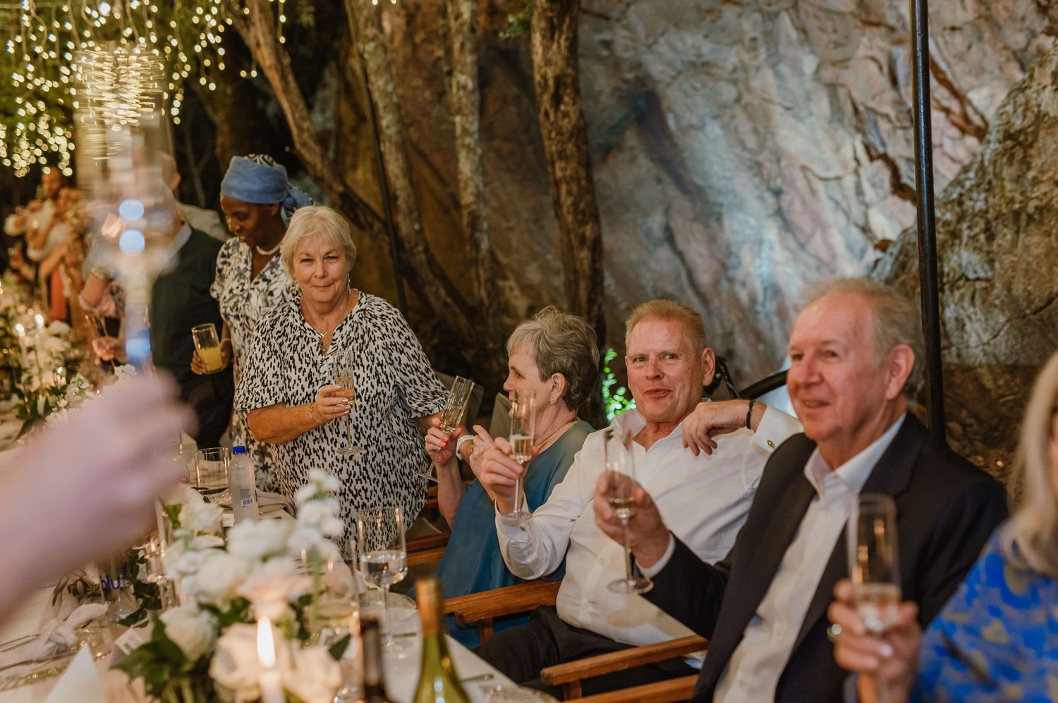 Candid moments of wedding guests celebrating at a beautifully lit reception venue.