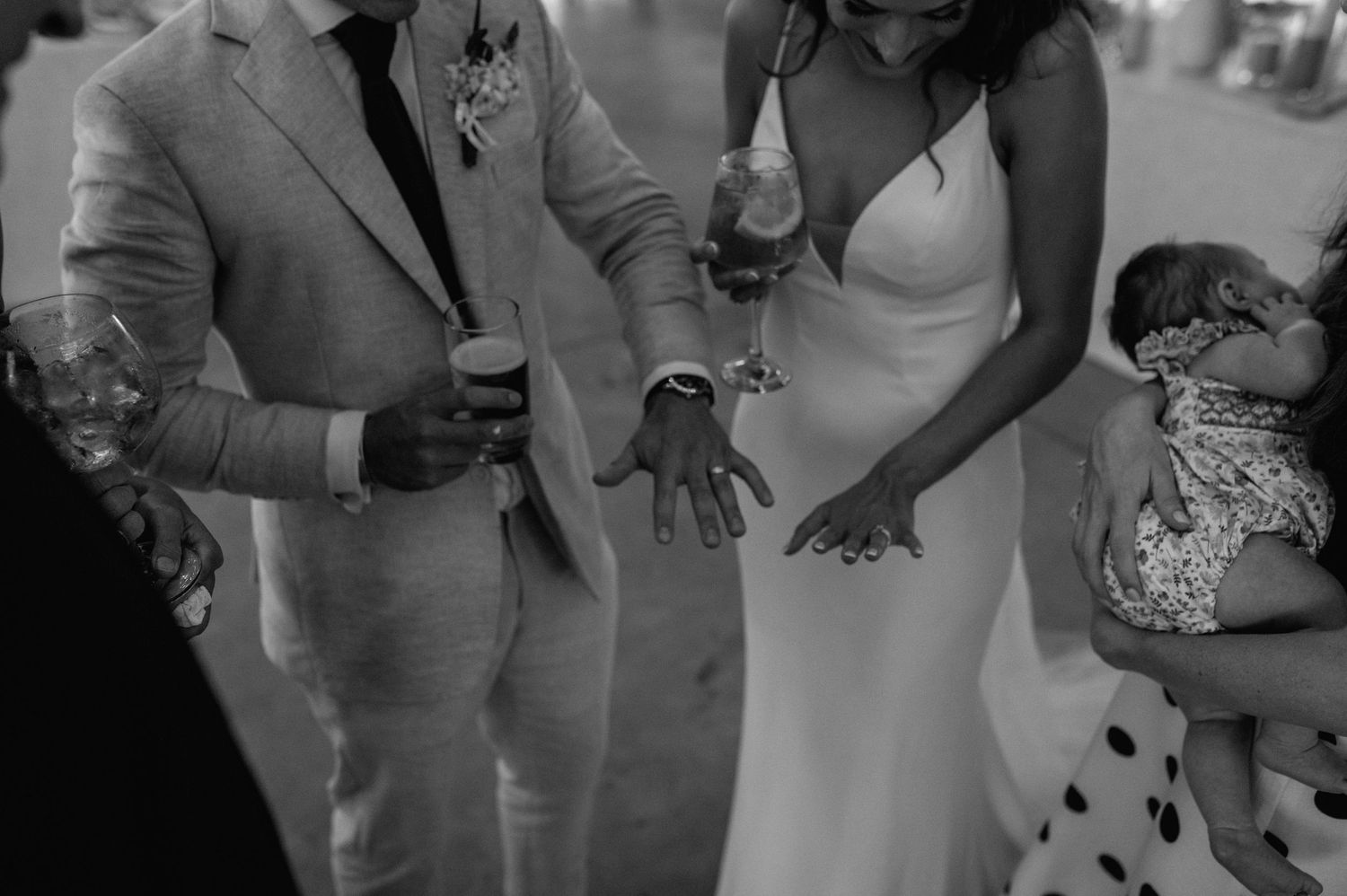 Wedding reception guests mingling and socializing in formal attire.