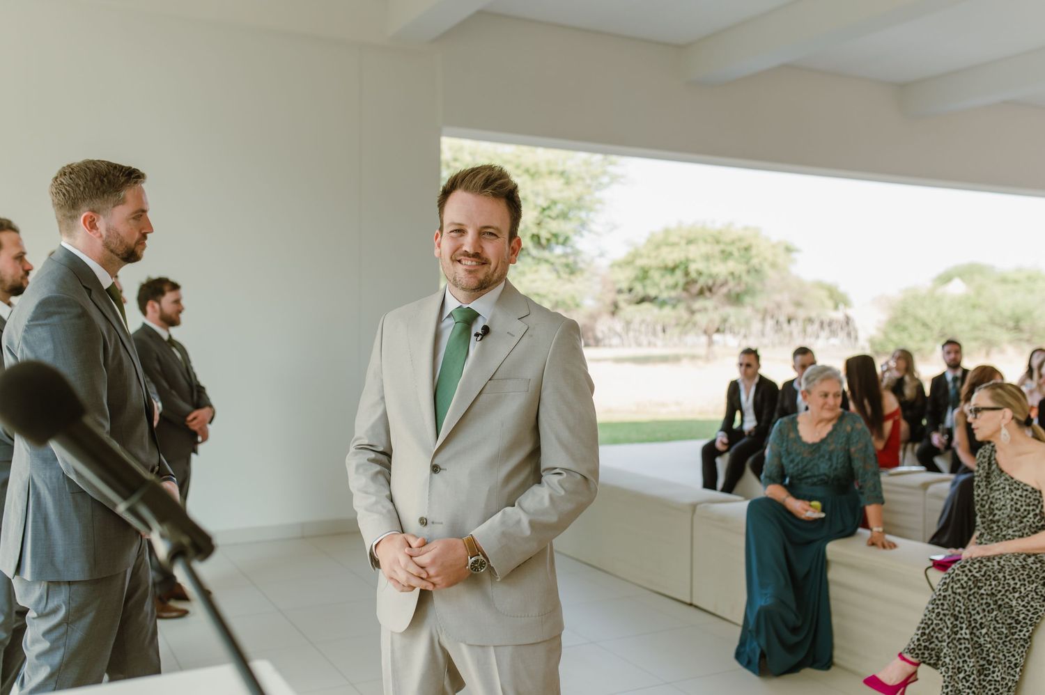 Bright interior space with people gathered for a formal occasion.
