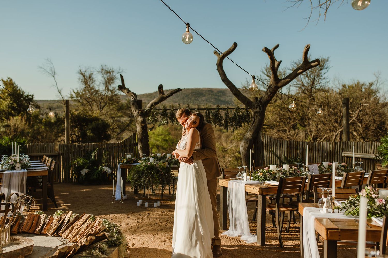Rustic outdoor wedding venue with natural decor and mountain views.