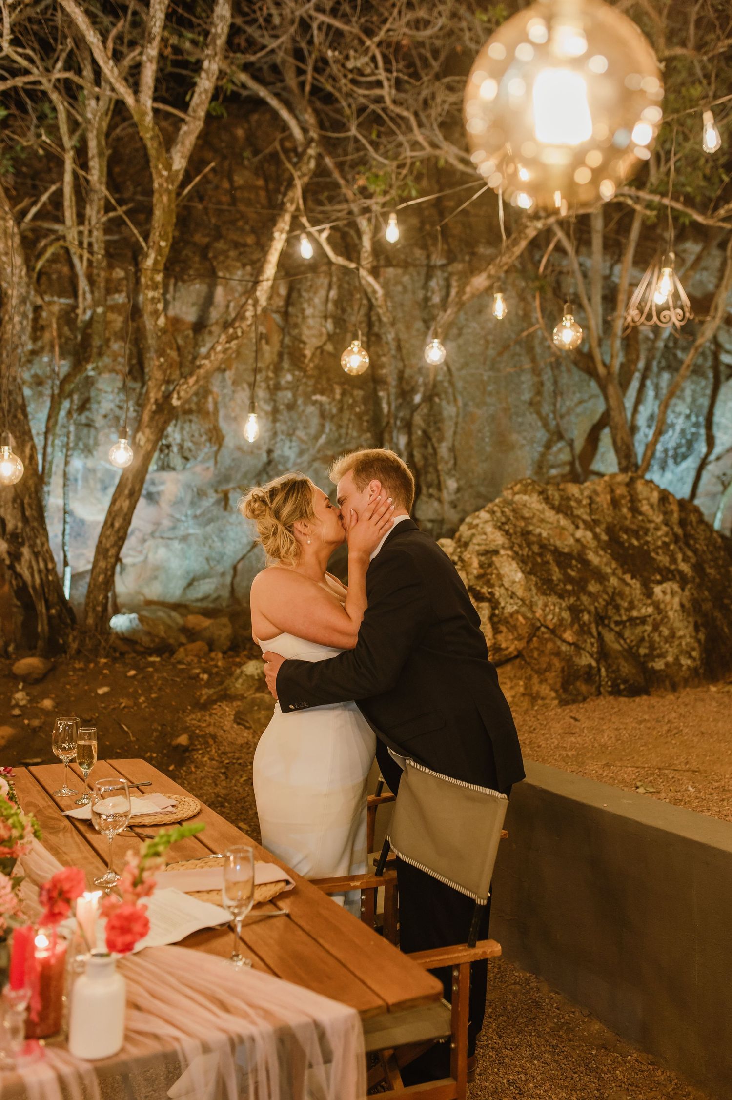 Romantic evening celebration under twinkling lights and trees.