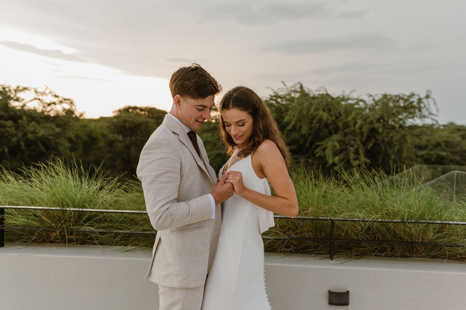 Romantic wedding portraits captured at scenic outdoor location with natural greenery.