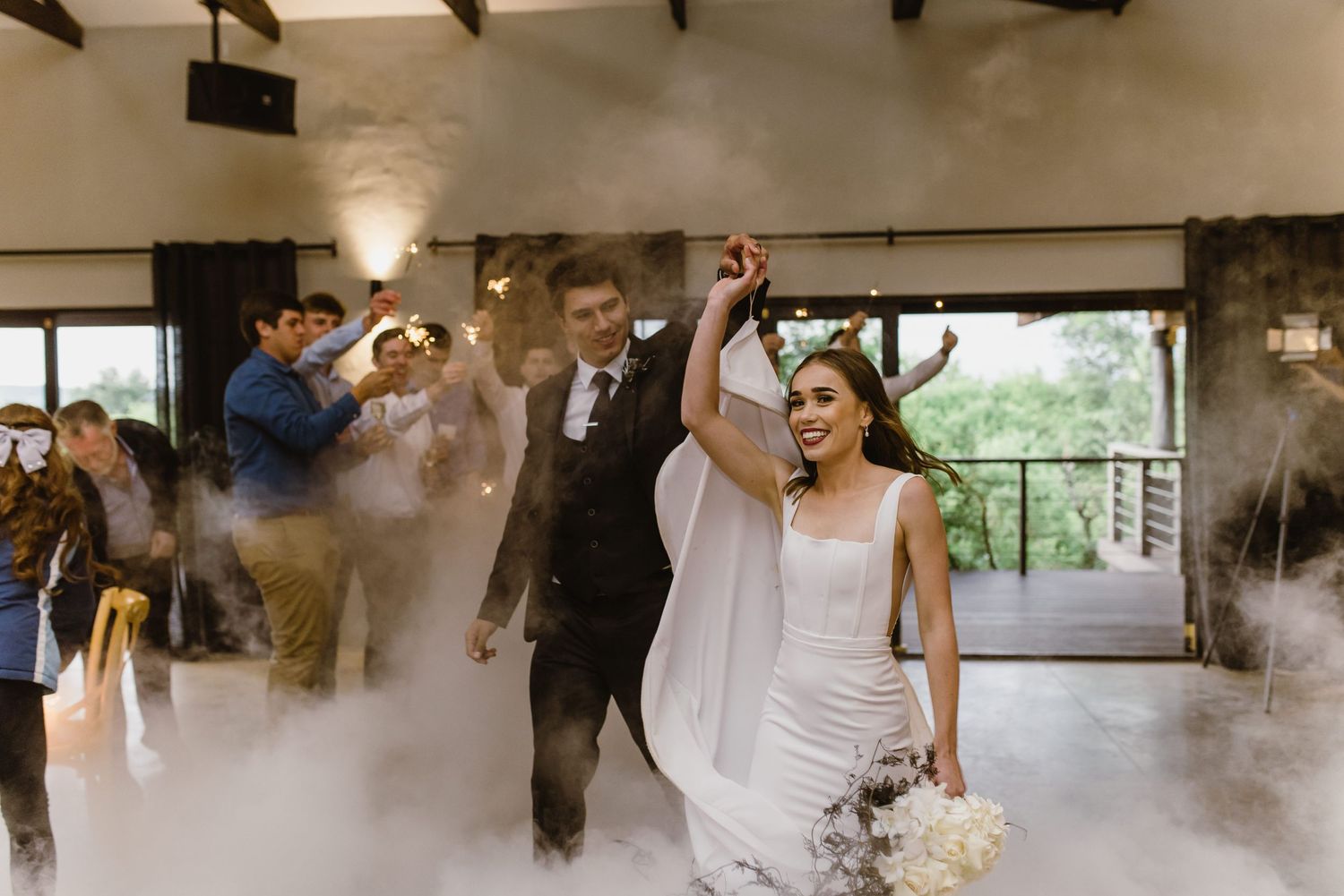 Celebration in progress with fog effects and natural lighting in an industrial-style venue.