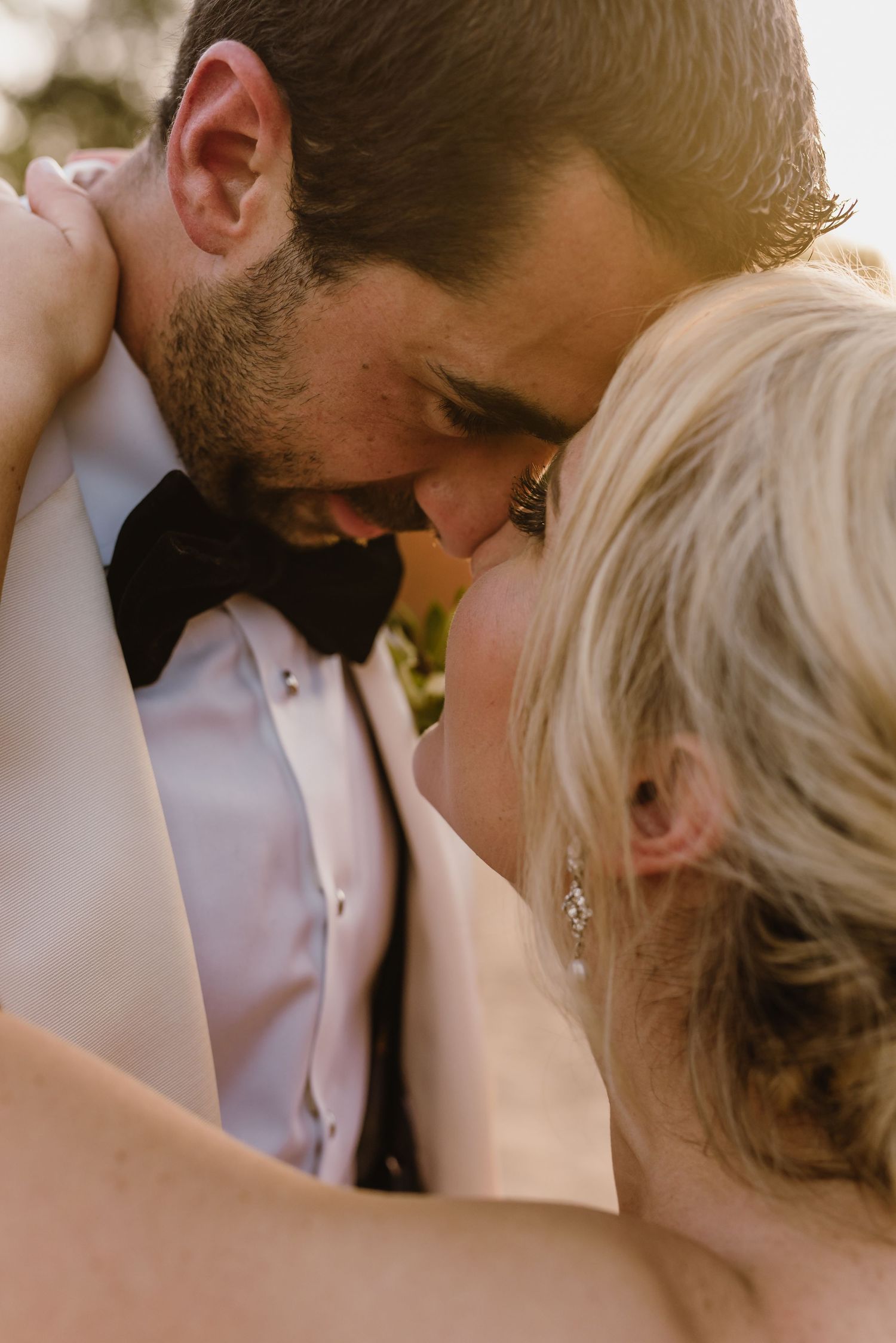 A romantic wedding moment captured in a series of four photos showing a tender kiss between the couple.