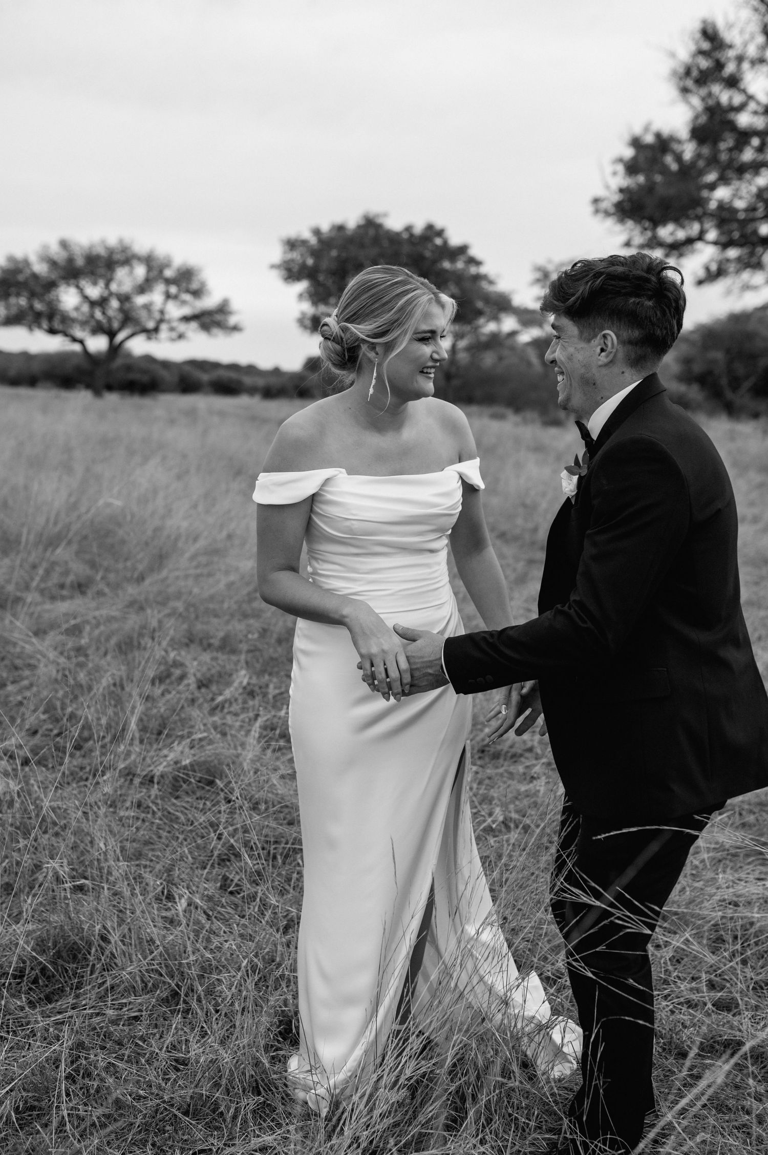 A series of romantic black and white wedding photos showing a couple dancing in tall grass.