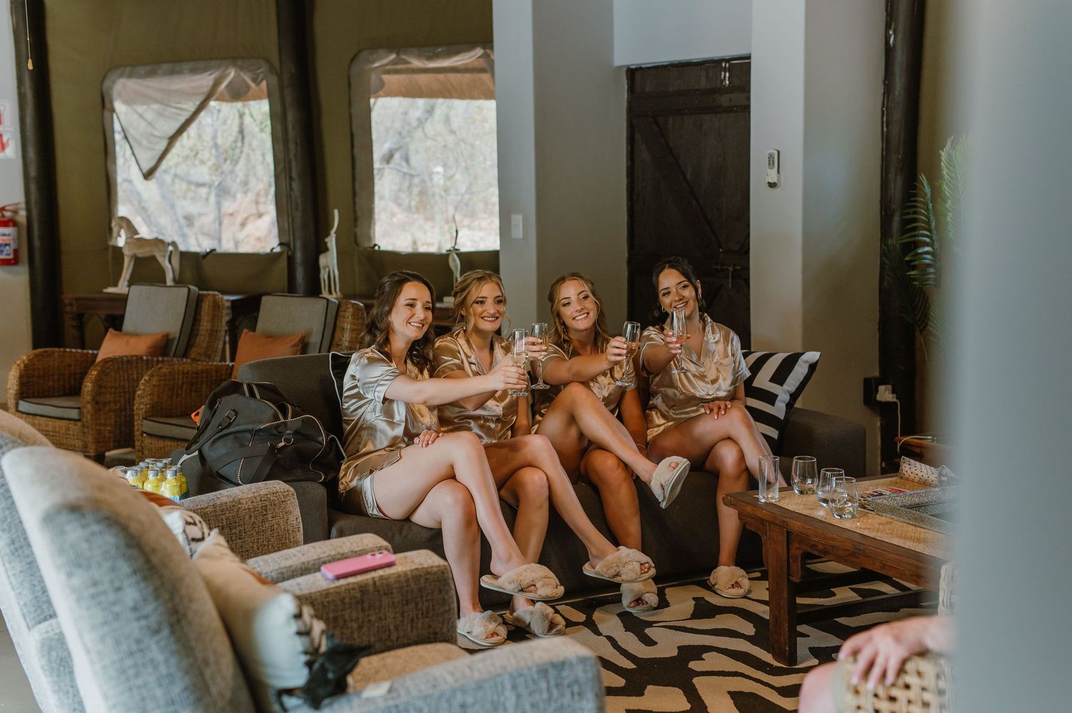 Group relaxing together on a couch in a cozy living room setting.
