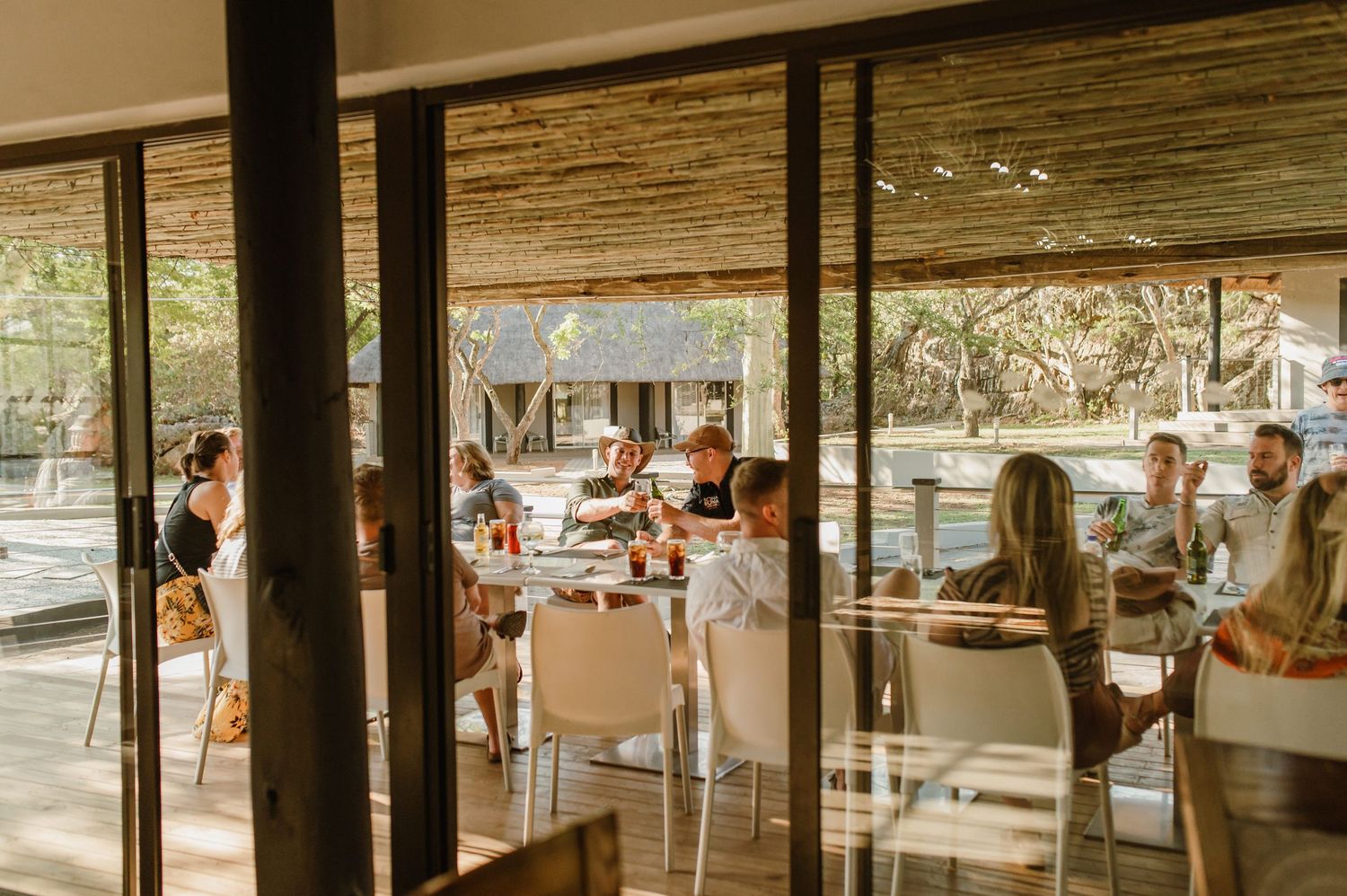 Interior view of a restaurant space with large windows and natural lighting.