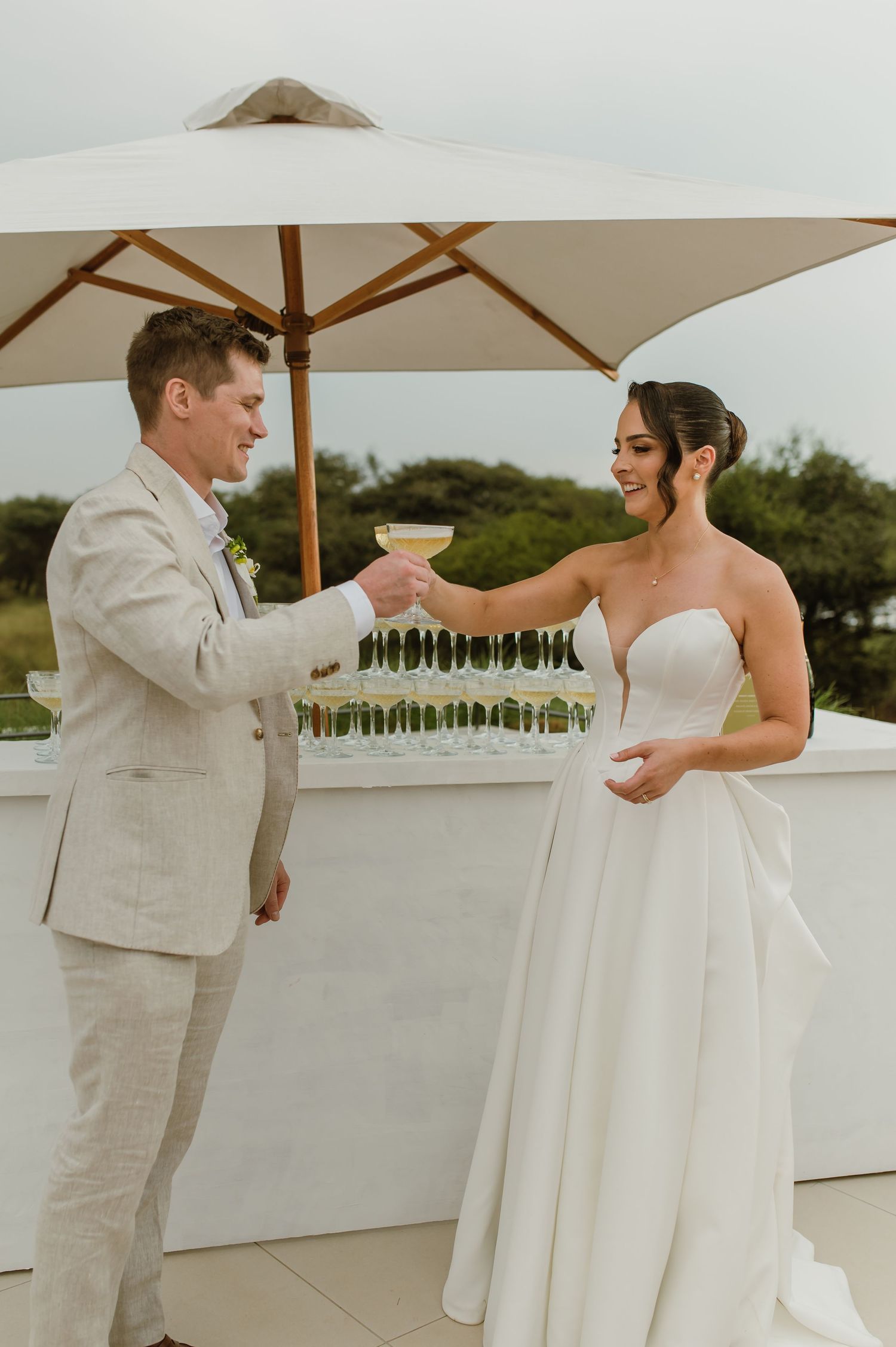 Couple sharing a romantic dance moment on an outdoor patio during a wedding celebration.
