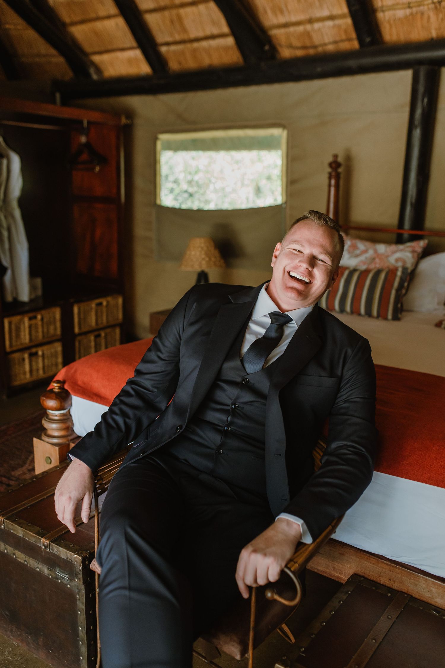 Candid moments captured in a rustic lodge with men in formal attire.