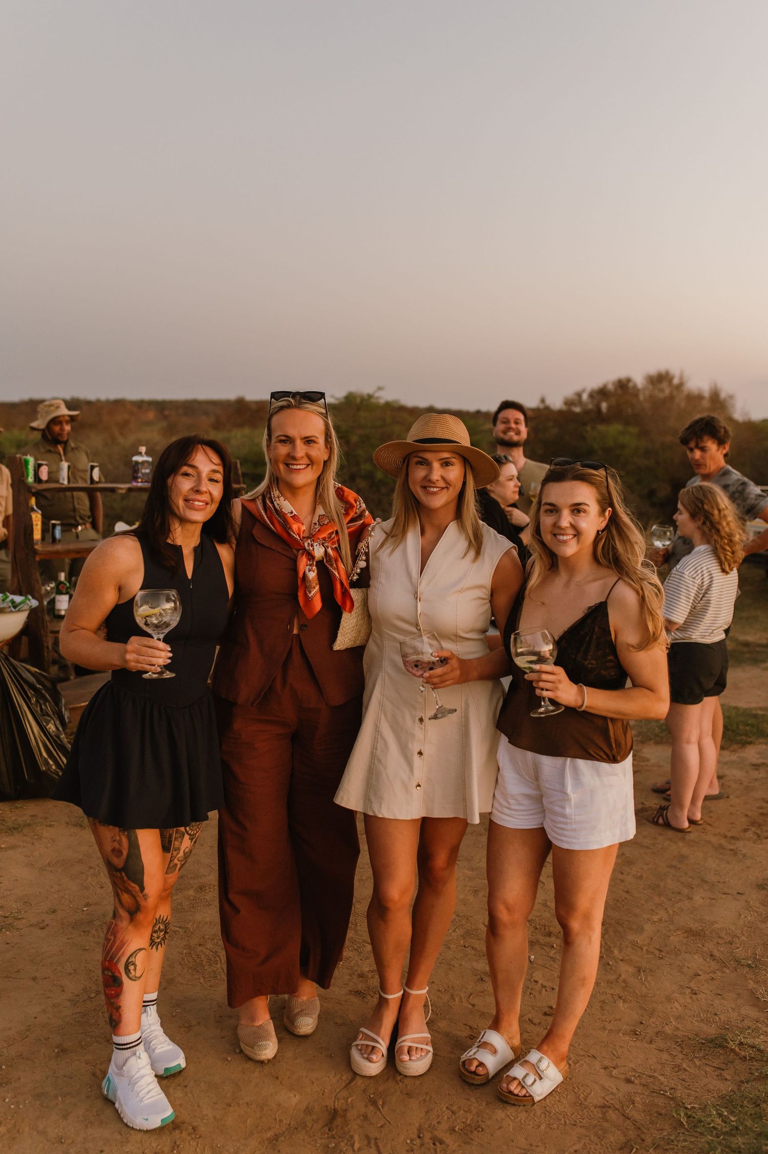 Friends posing together for a group photo at an outdoor celebration.