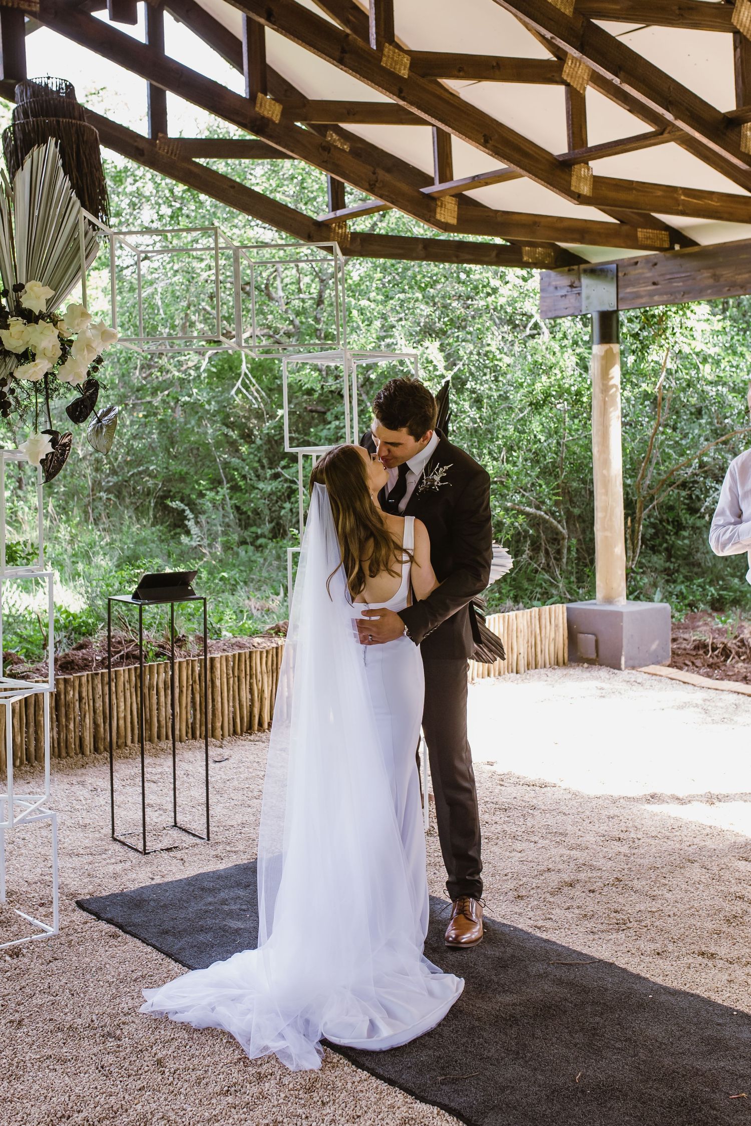 Romantic first dance sequence under a covered outdoor pavilion.