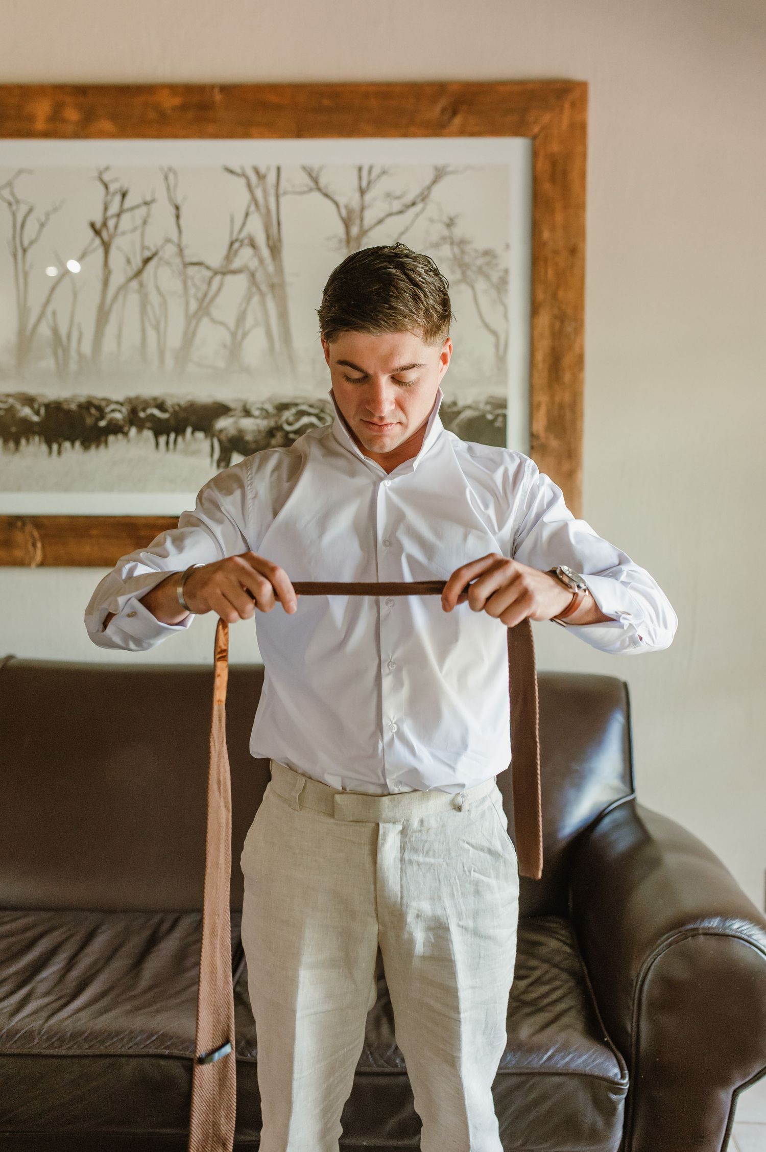 A sequence showing someone adjusting suspenders over a crisp white dress shirt.