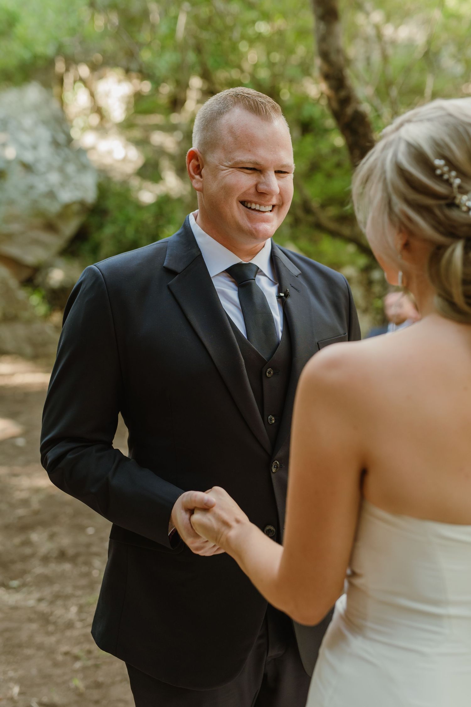 Joyful moments shared between a couple during their forest wedding ceremony.
